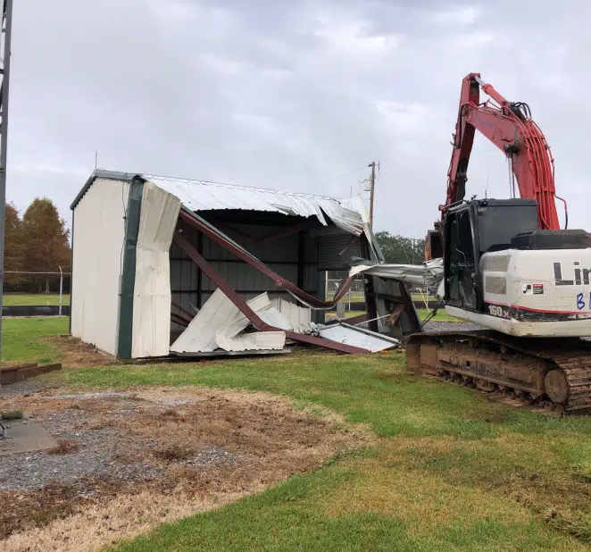 Excavator demolishing outdoor structure at the Lafayette Airport